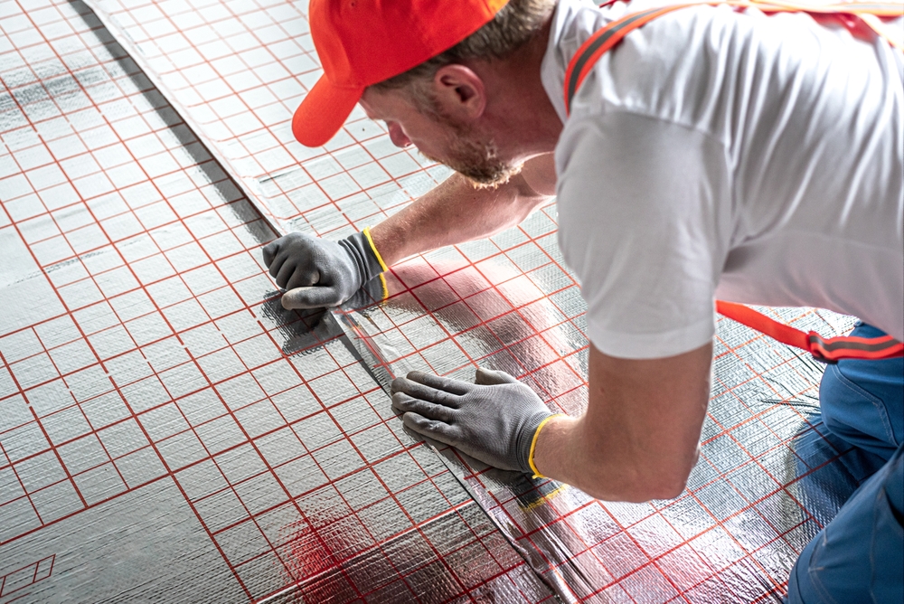 Work,On,Underfloor,Heating.,Sticking,Foil,Of,A,Underfloor,Heating