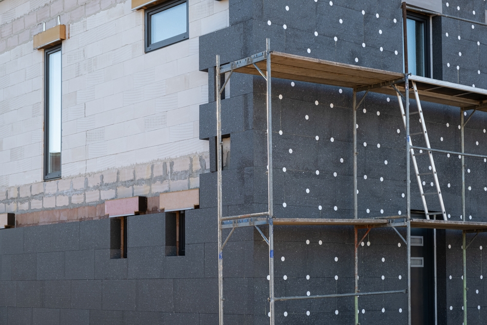 New,House,Building,In,Process,Insulation,Of,The,Wall,Of
